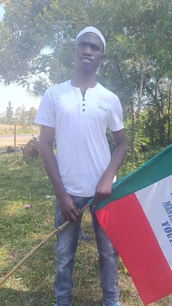 Youth Member holding Manyatta Flag